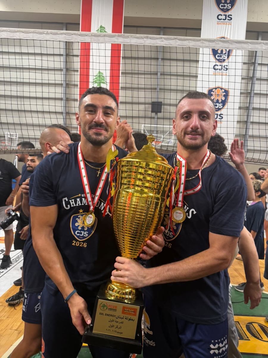 Omar and a teammate holding the Lebanese first division trophy, 2025-26